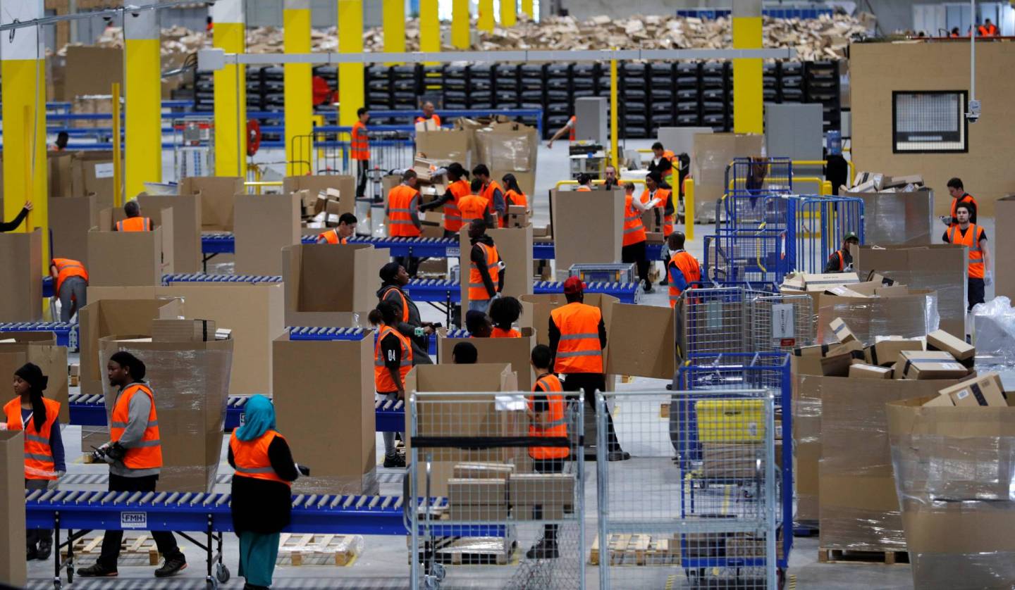 Employees work at the Amazon distribution center in Saran, near Orleans