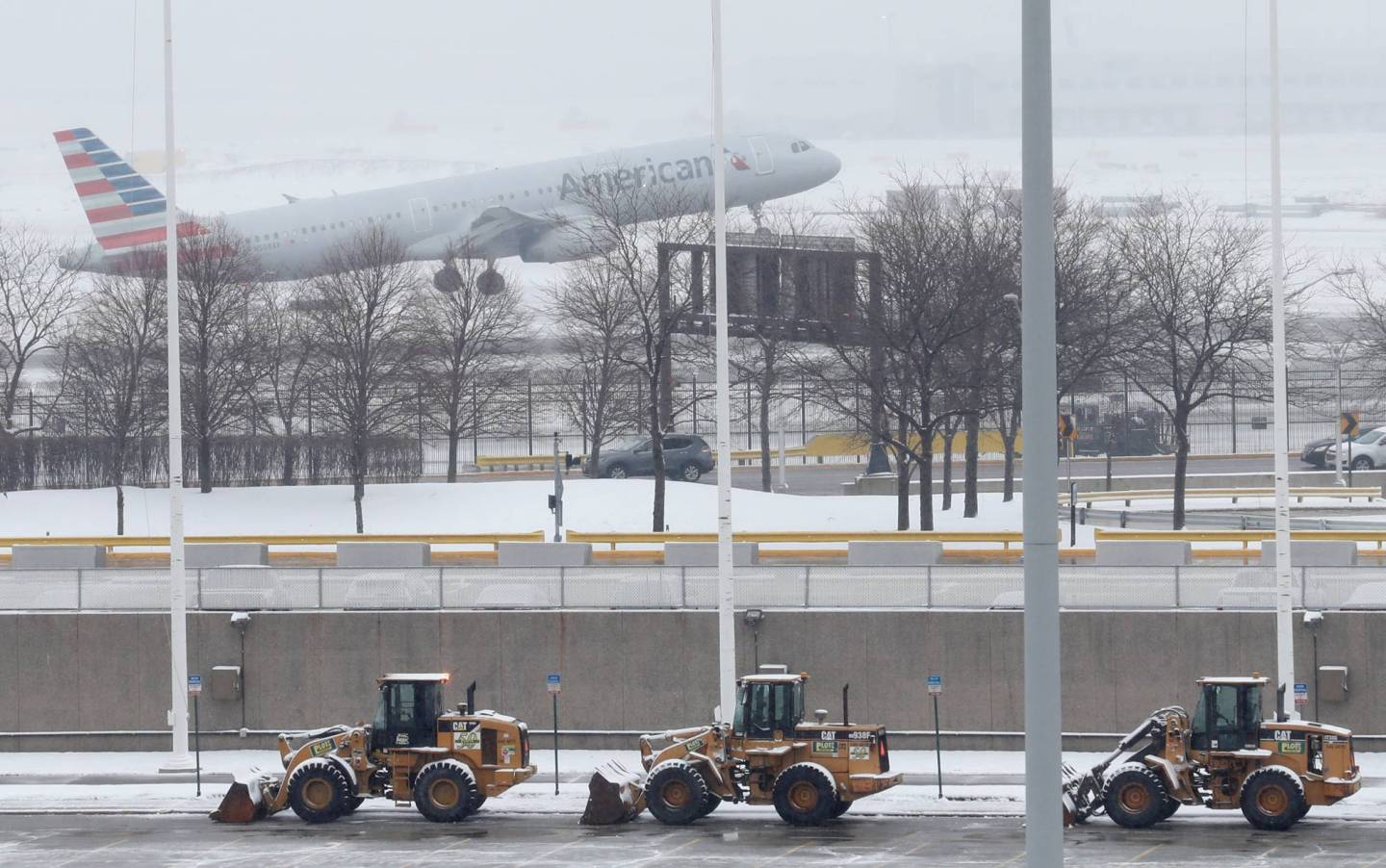 An American Airlines plane departs during the snowstorm at O'Hare International Airport in Chicago