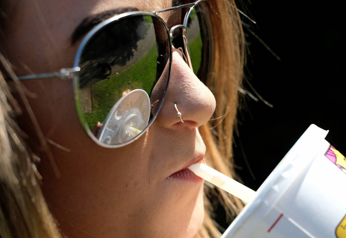 A woman drinks a McDonalds refreshment with a straw in Loughborough