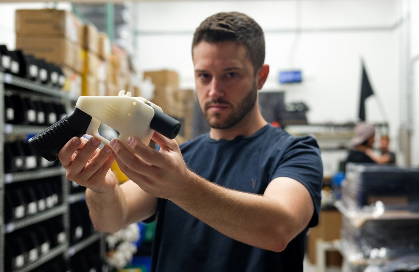 Cody Wilson, owner of Defense Distributed, holds a 3D-printed gun in his factory in Austin, Texas, on Aug. 1, 2018.