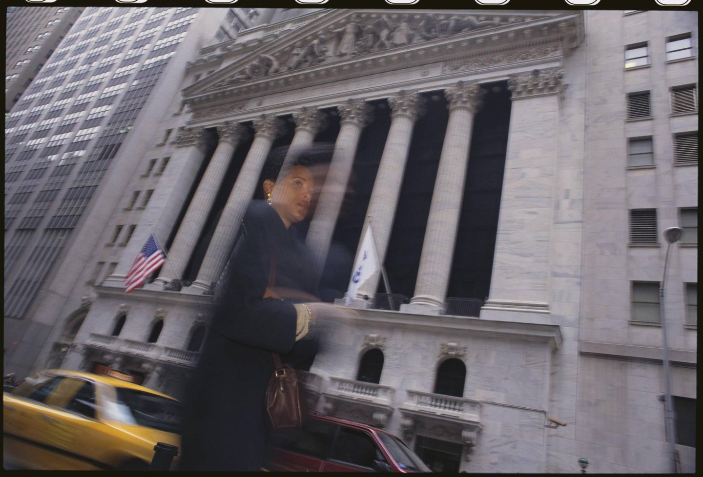 Woman Walks Past the New York Stock Exchange