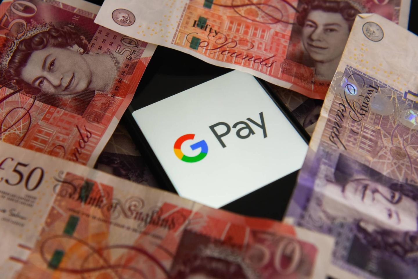 Fifty and twenty pounds bank notes and Google Pay logo are