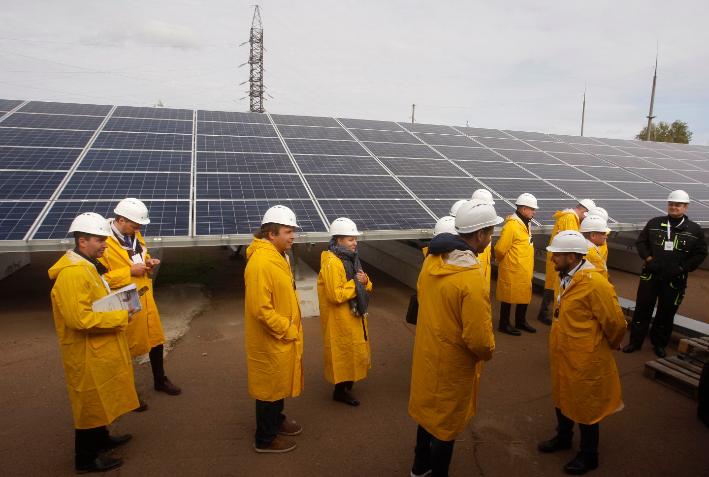 Visitors seen standing next to a solar photovoltaic elements