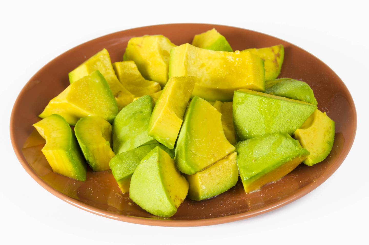 Pieces of avocado in a plate. Avocado cut into pieces and