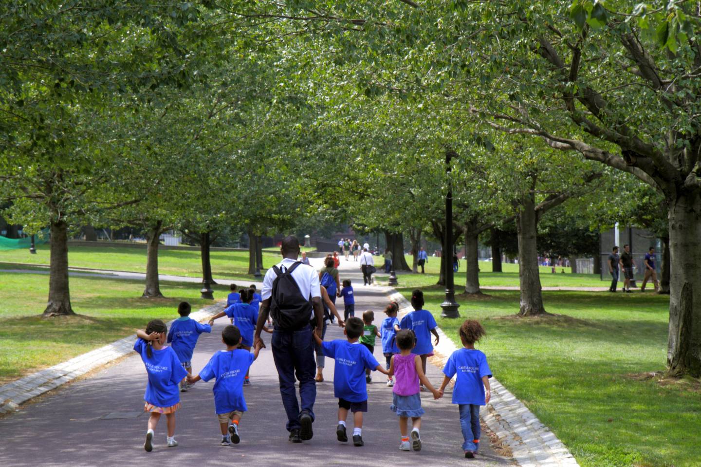 A daycare class walking in a public park in Boston Common.