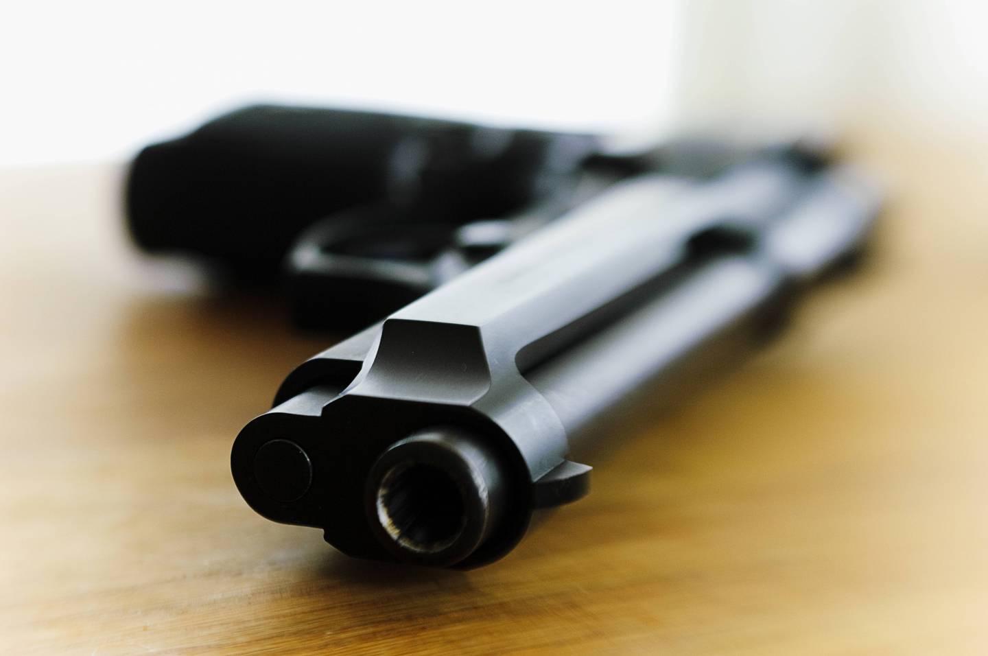 A pistol on a table.