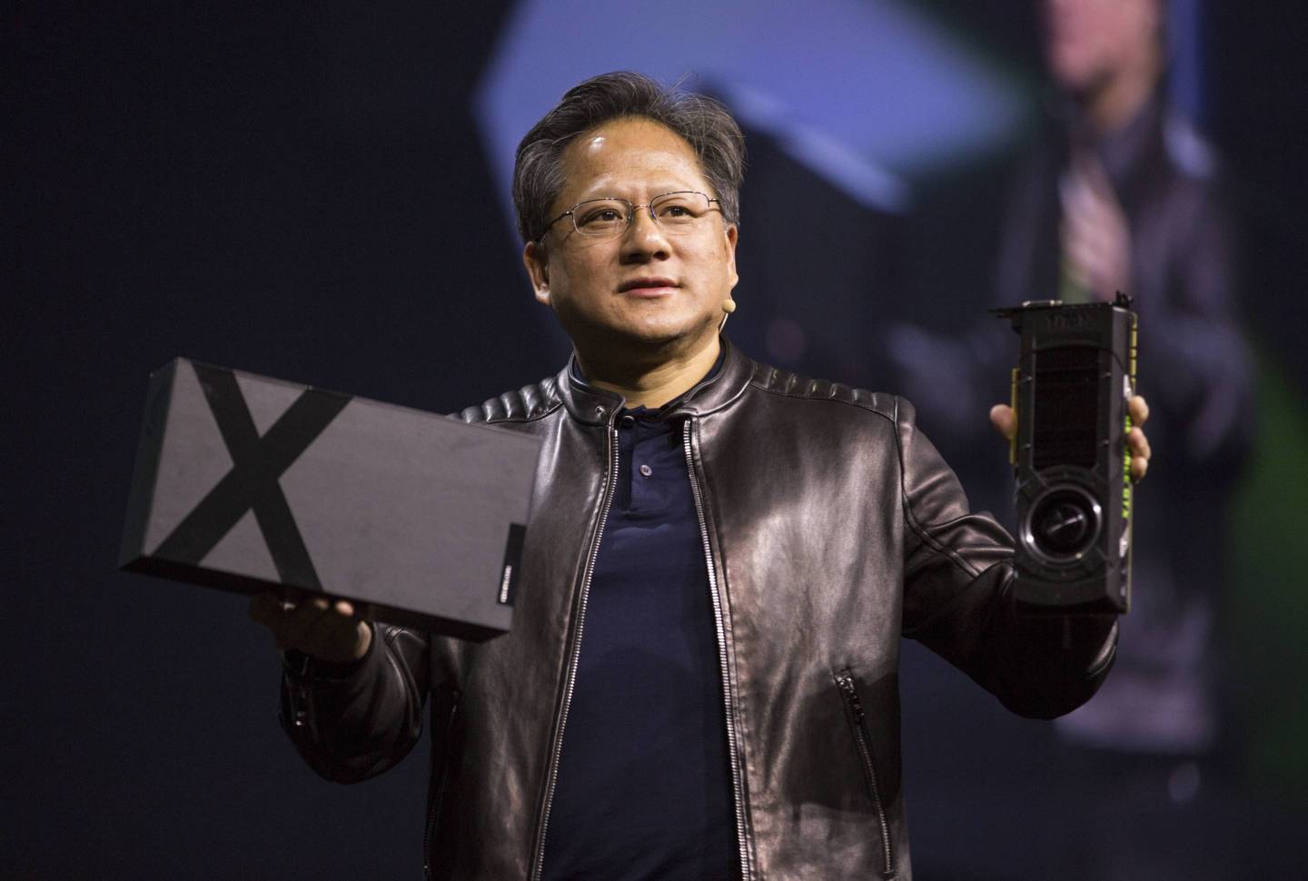Nvidia CEO Jensen Huang shows off new graphics cards during the GPU Technology Conference in San Jose, Calif.
