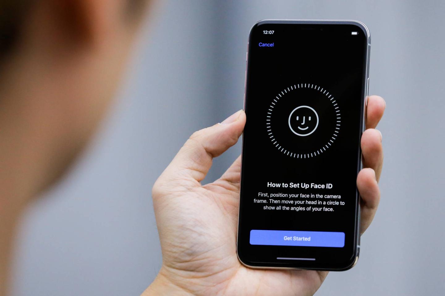 An attendee uses the Face ID function on the new iPhone X during a presentation for the media in Beijing