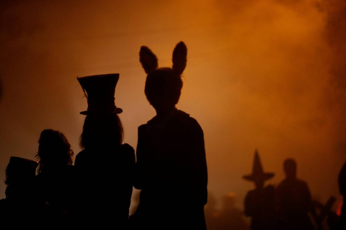 People wearing costumes walk during Halloween in Sierra Madre