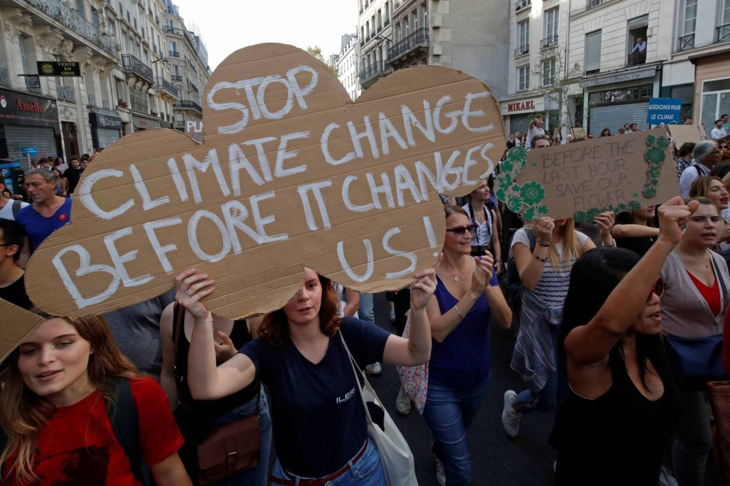 Protesters march to urge politicians to act against climate change in Paris