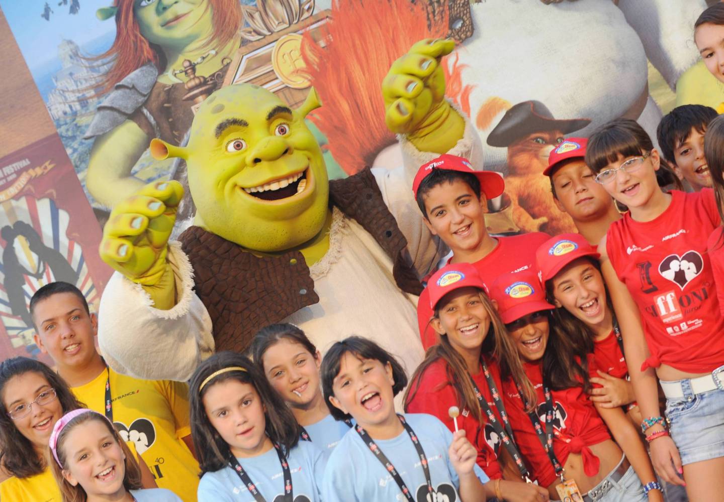 An actor dressed Shrek poses for a photo