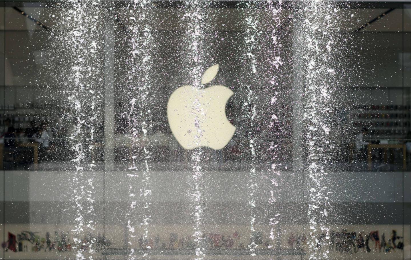 Logo of an Apple store, seen from a music fountain on the