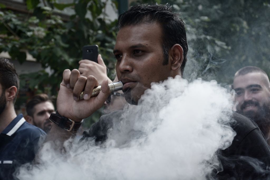 A protester seen smoking vapor cigarette during the protest