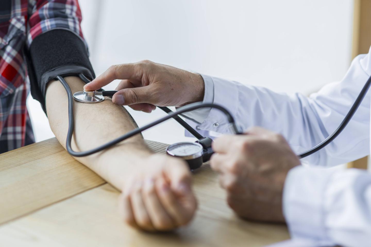 Doctor Measuring arterial blood pressure woman patient on right arm Health care in hospita