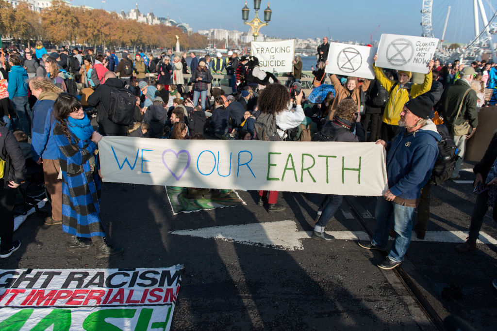 Environmental activists seen holding a banner on Westminster