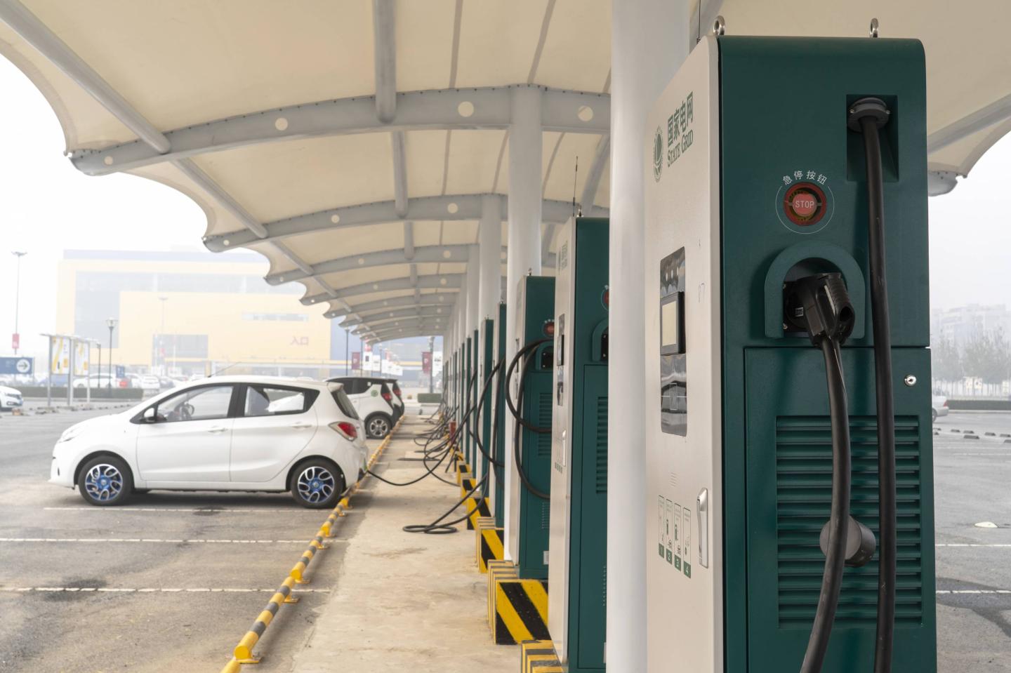 A charging station on a parking lot in a hazy day.  Facing
