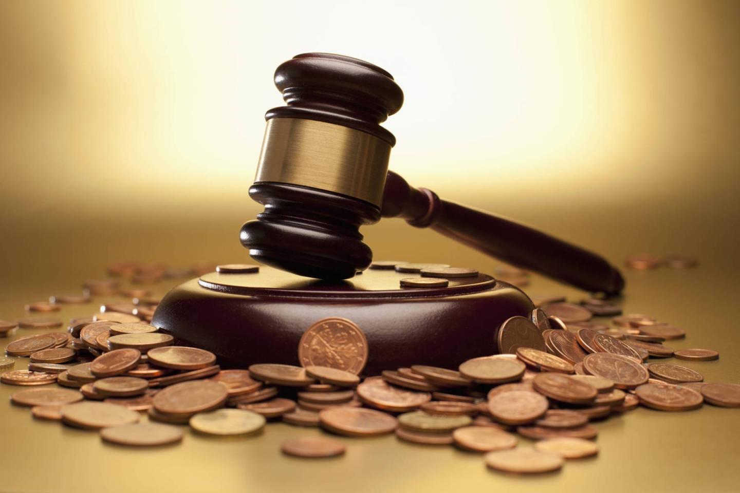 Gavel and sound block surrounded by euro coins