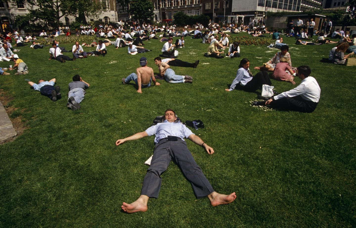 England - London - City office worker sunbathe during hot lunchtime
