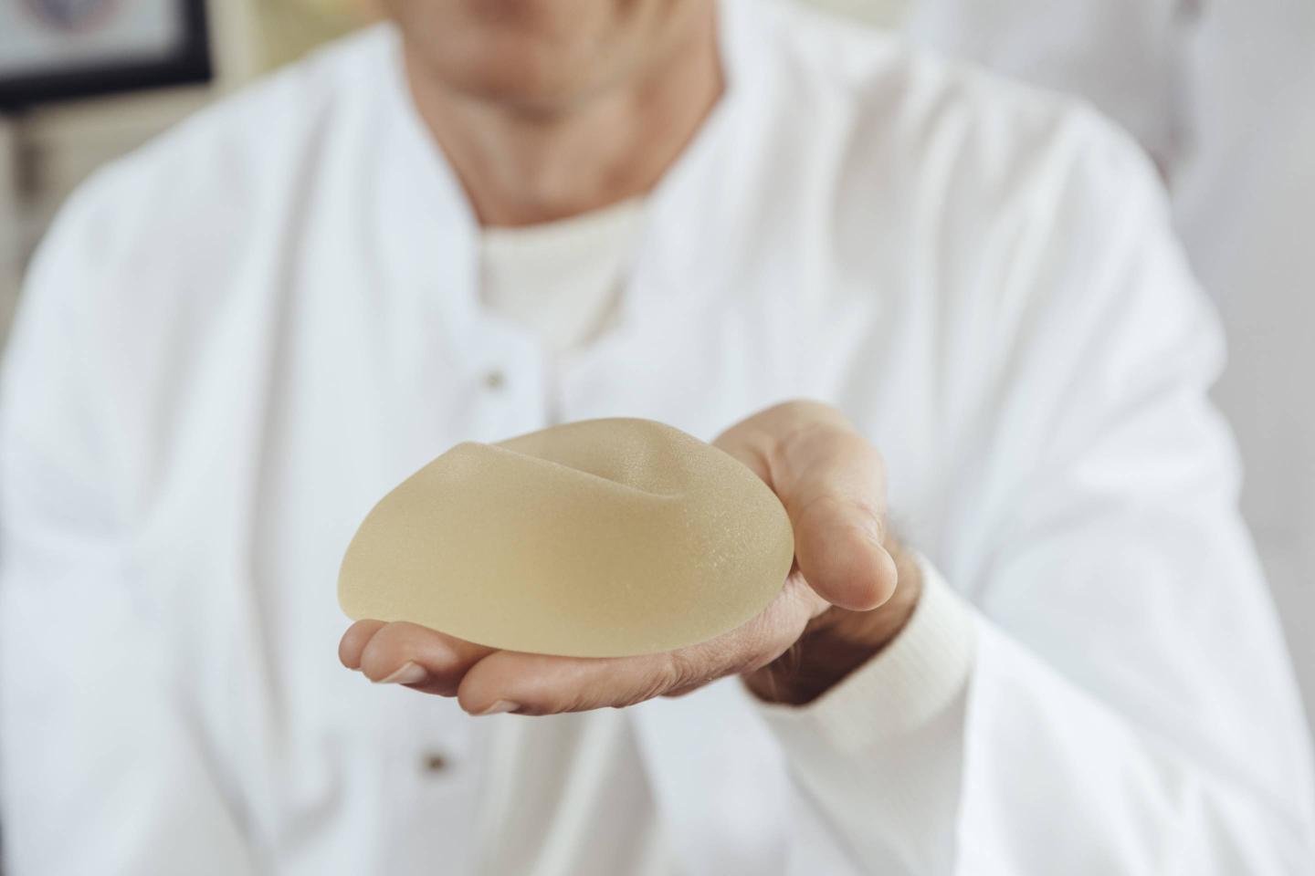 Doctor showing a silicone breast implant