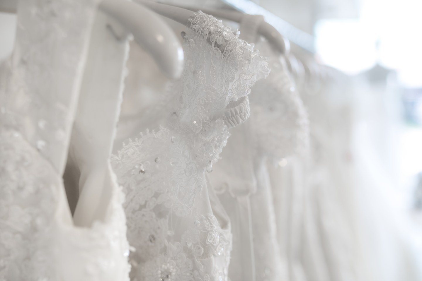 Close-Up Of Wedding Dresses In Bridal Shop