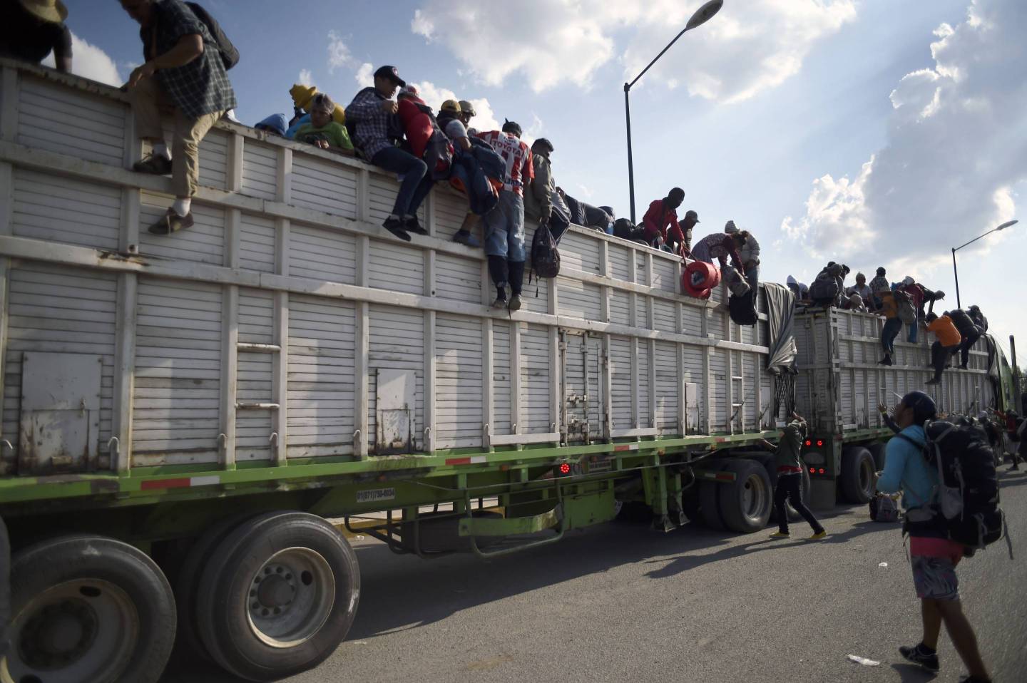 Central American migrants descend from a truck at a temporary shelter in Irapuato, Mexico, on Nov. 11, 2018.