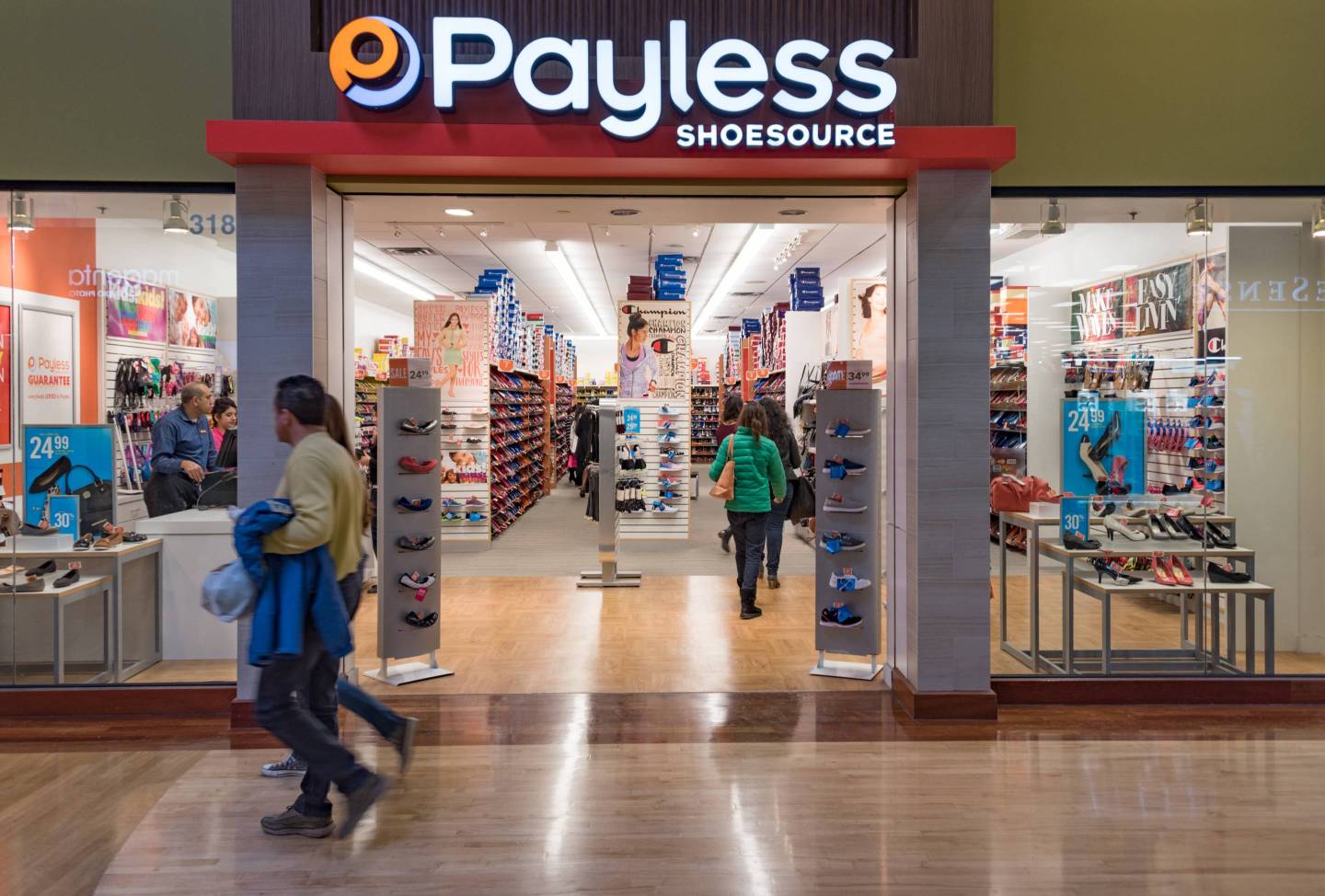 Payless Shoe Store, Couple walking in a mall corridor