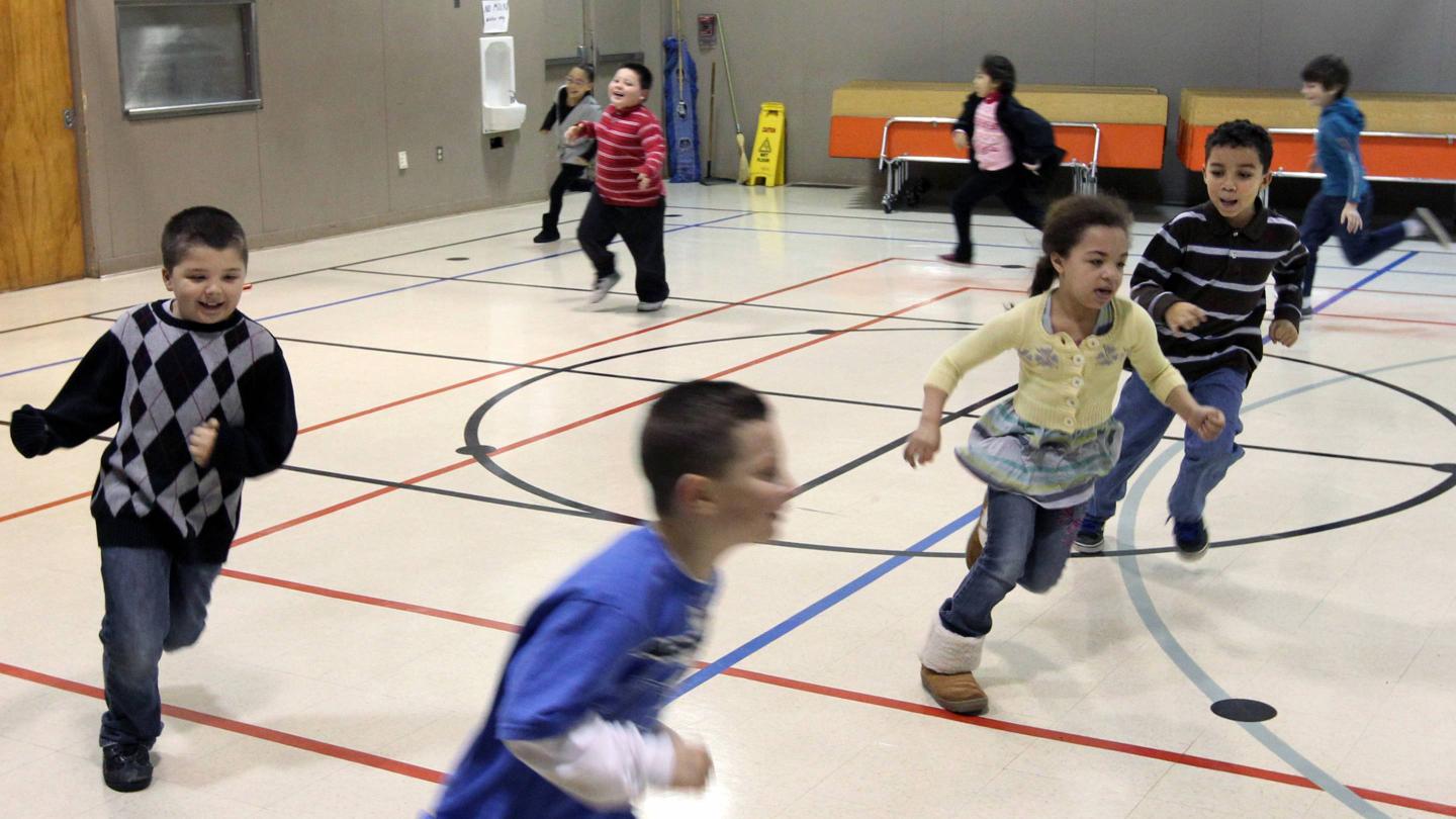 Second graders at Brookdale Elementary School run laps around the gym during a physical education class in Parkland, Wash., on Jan. 3, 2012.
