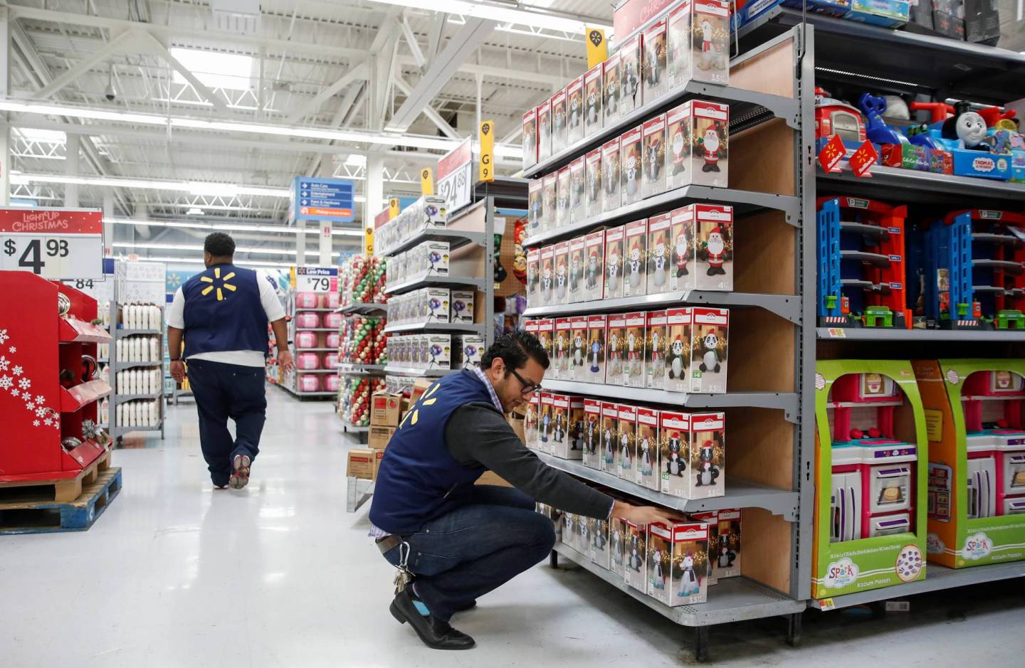 An employee works on a display ahead of Black Friday at a Walmart store in Chicago