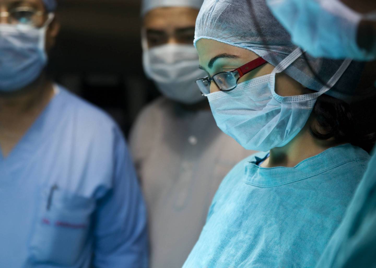 A surgeon performs an operation.