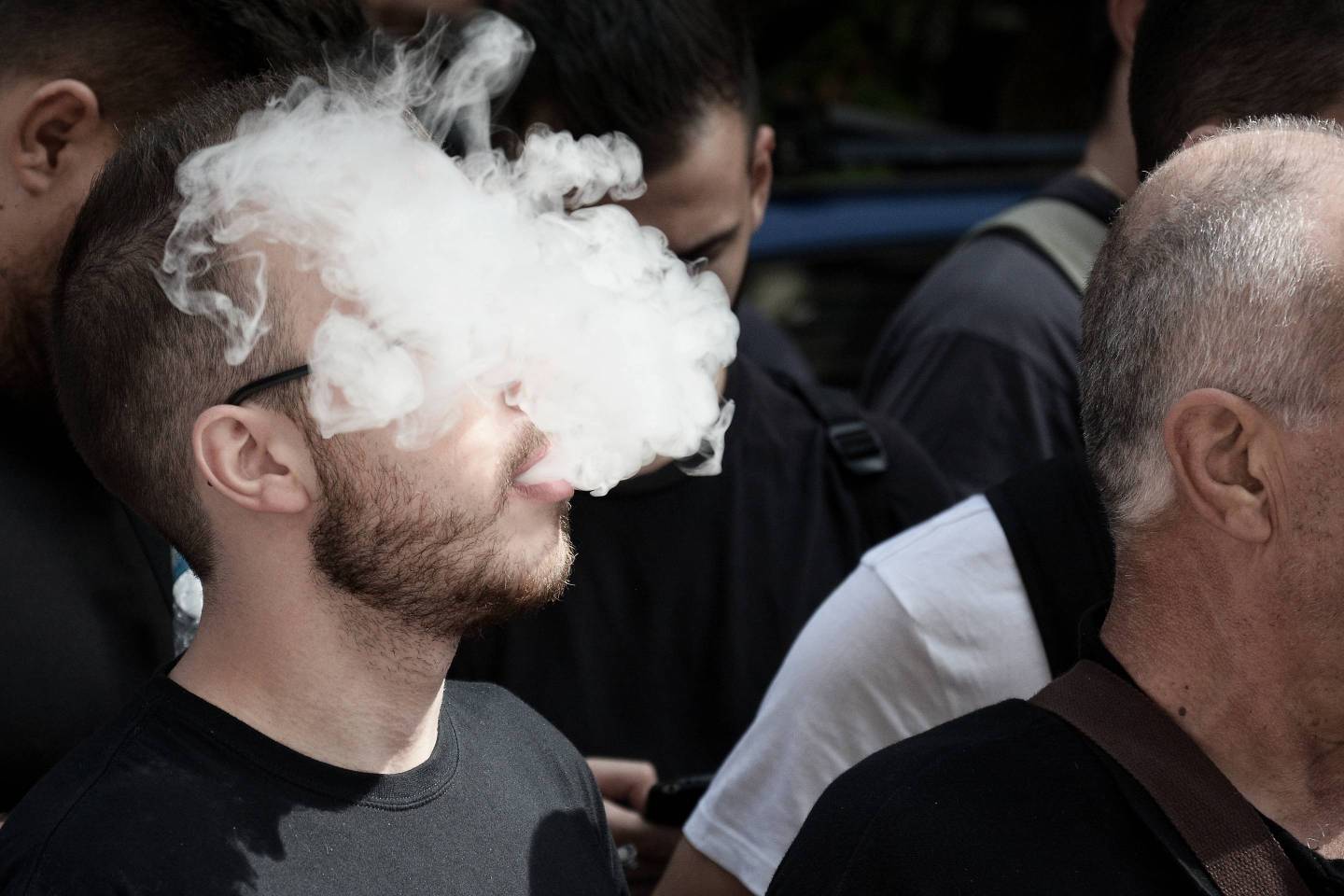 A protester seen smoking vapor cigarette during the protest