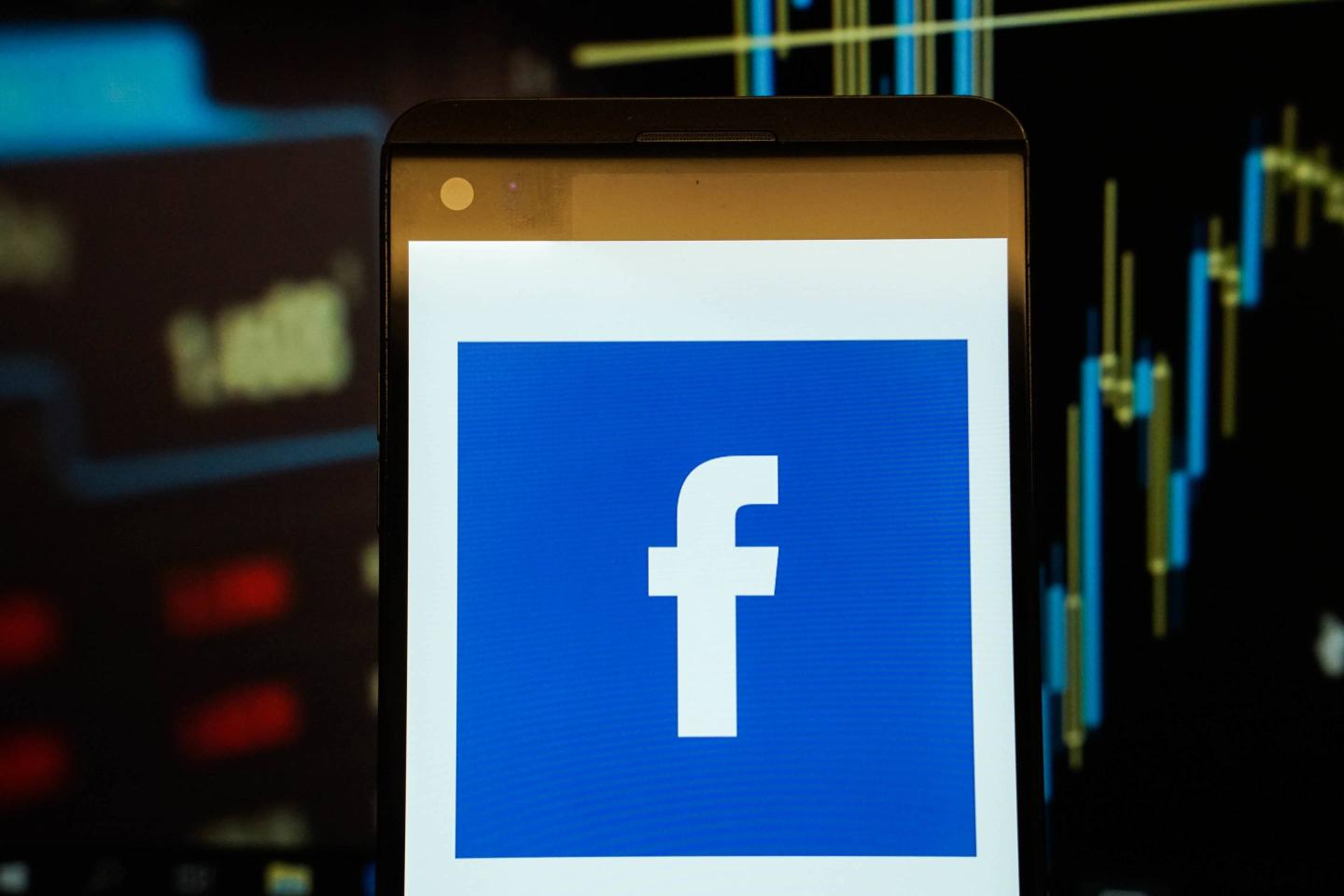 The logo of  Facebook is seen in a smartphone