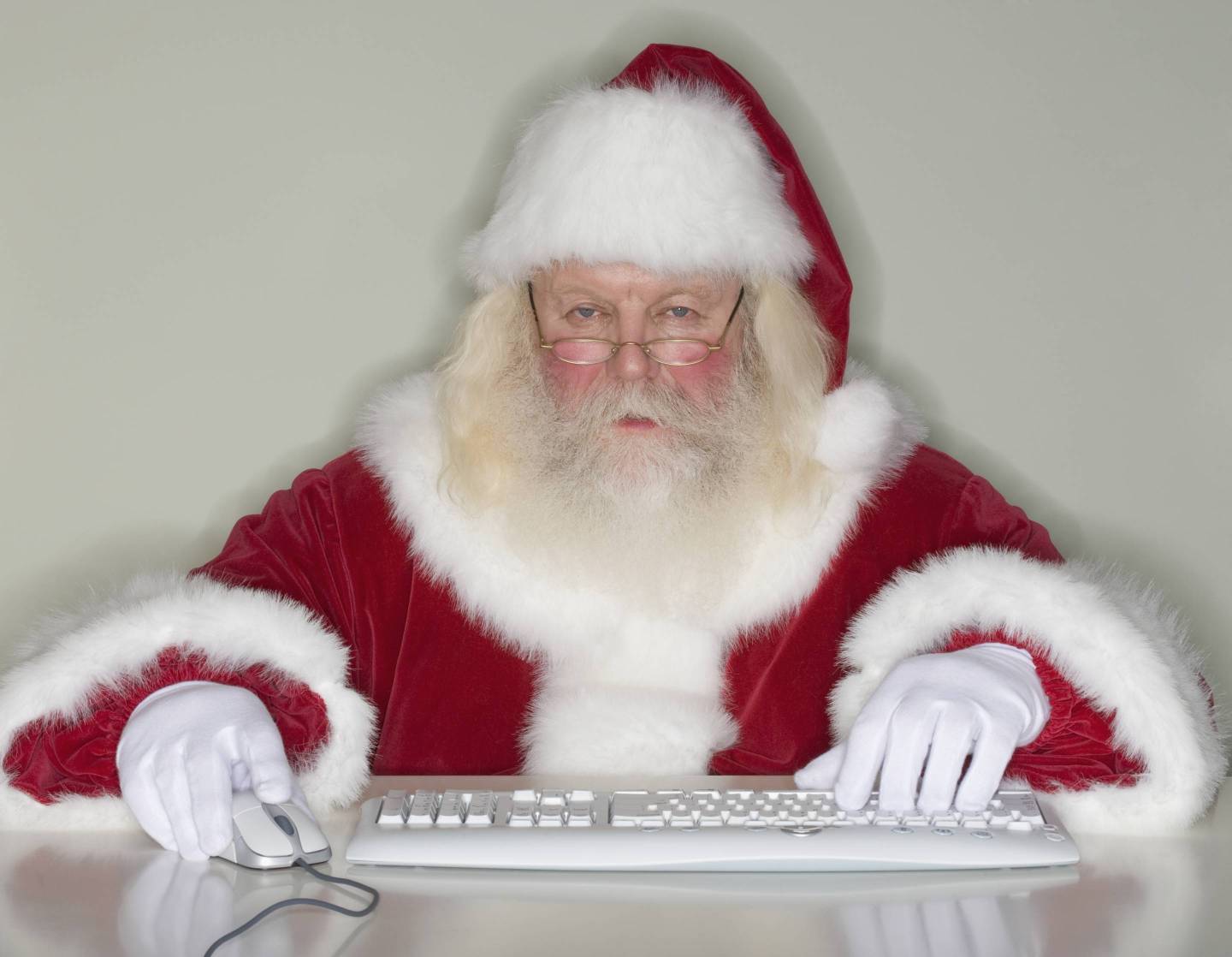 Santa Claus typing on computer