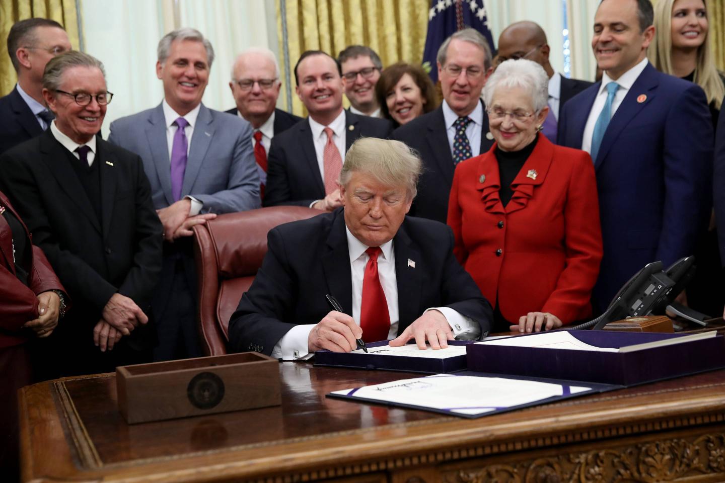 President Donald Trump signs the First Step Act in the Oval Office of the White House on Dec. 21, 2018.