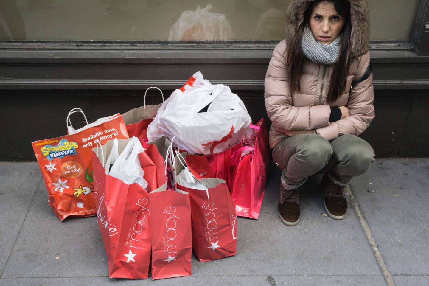 A shopper and her bags outside Macy's Department Store in Manhattan,