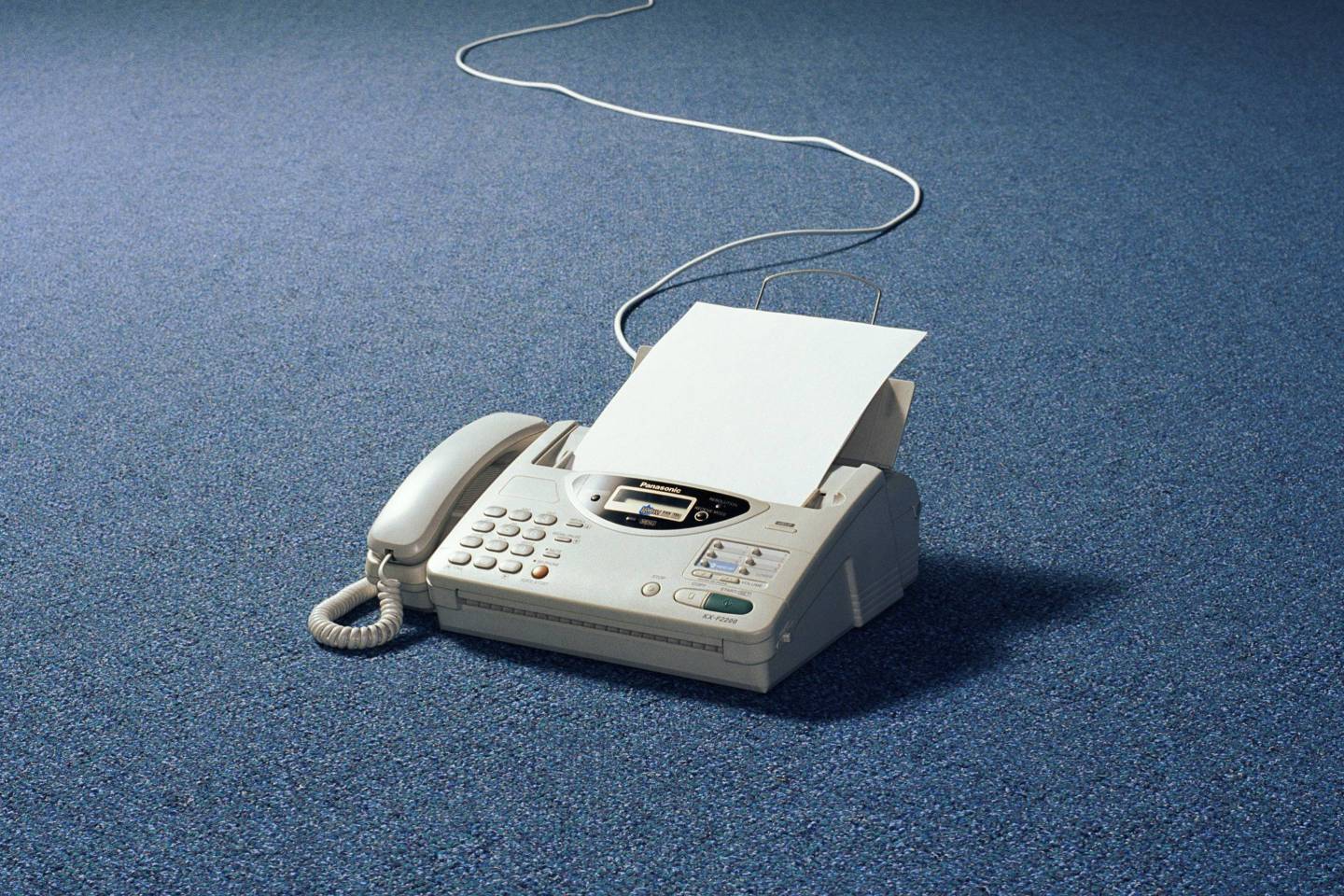 Fax machine on floor of empty room
