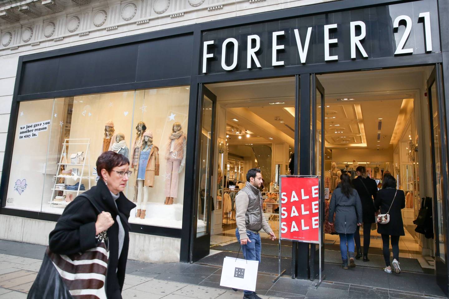 Shoppers are seen outside Forever 21 store on London's