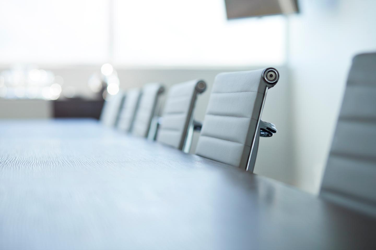 Row of empty chairs in board room