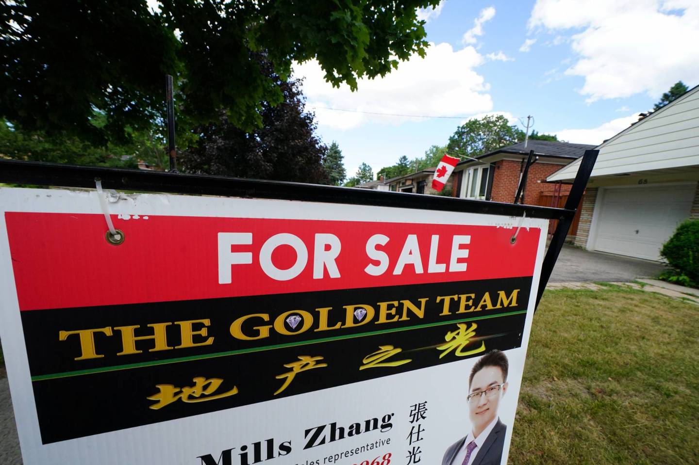 'For Sale' sign is pictured in the front yard of a house in Toronto