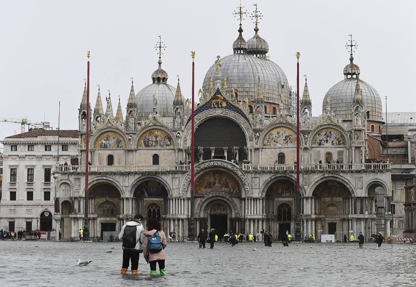 Tourists walk in Piazza San Marco on Oct. 29, 2018, as Venice is inundated by near-record flooding and ferocious storms.