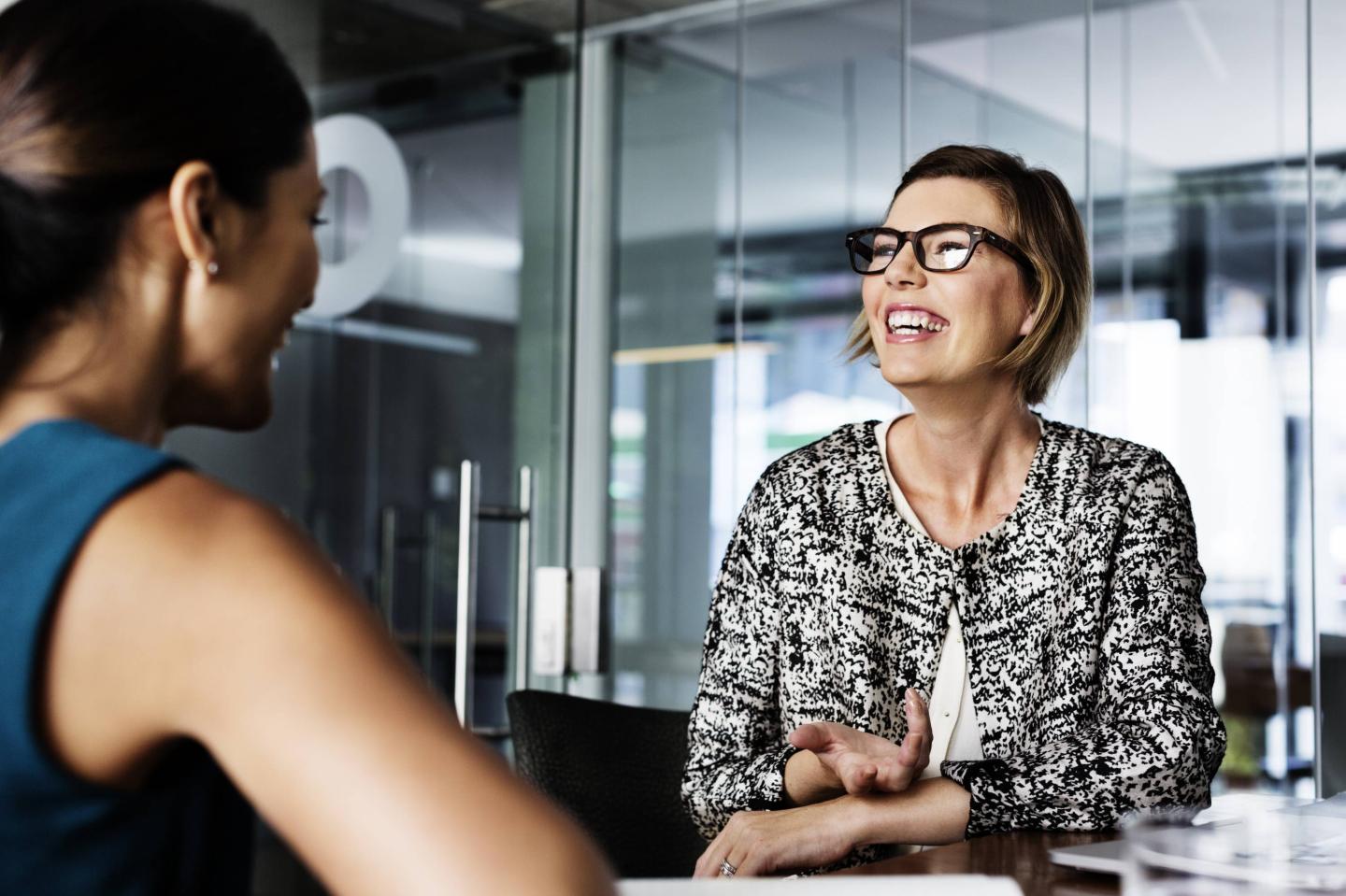 Happy businesswomen discussing in office