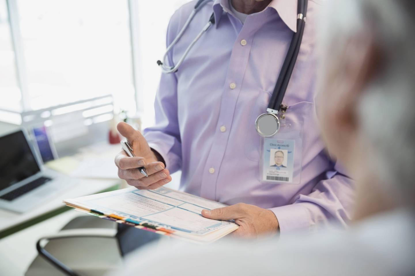 Doctor reviewing medical chart with patient