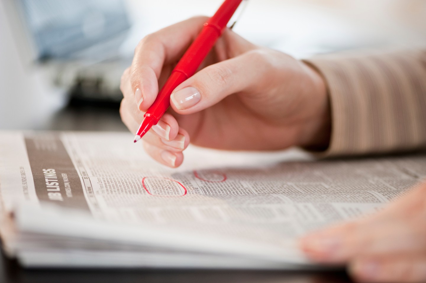 Woman circling classfields, close-up