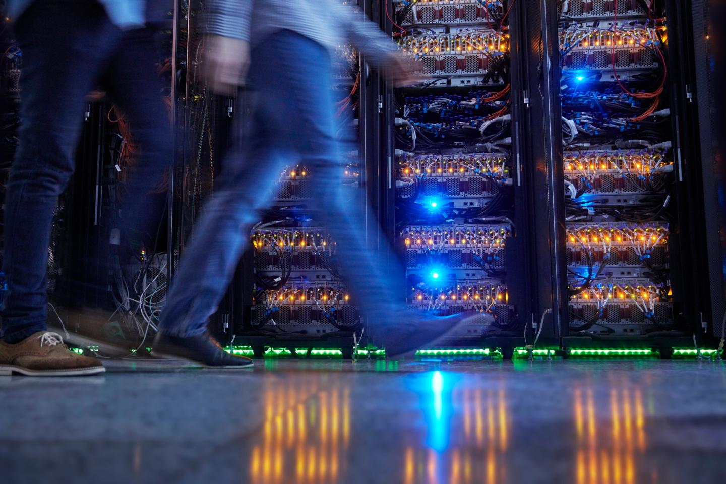 IT technicians walking in dark server room