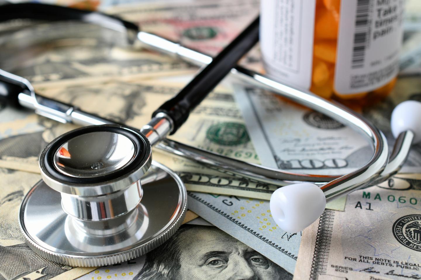 Close-Up Of Stethoscope On Paper Currency