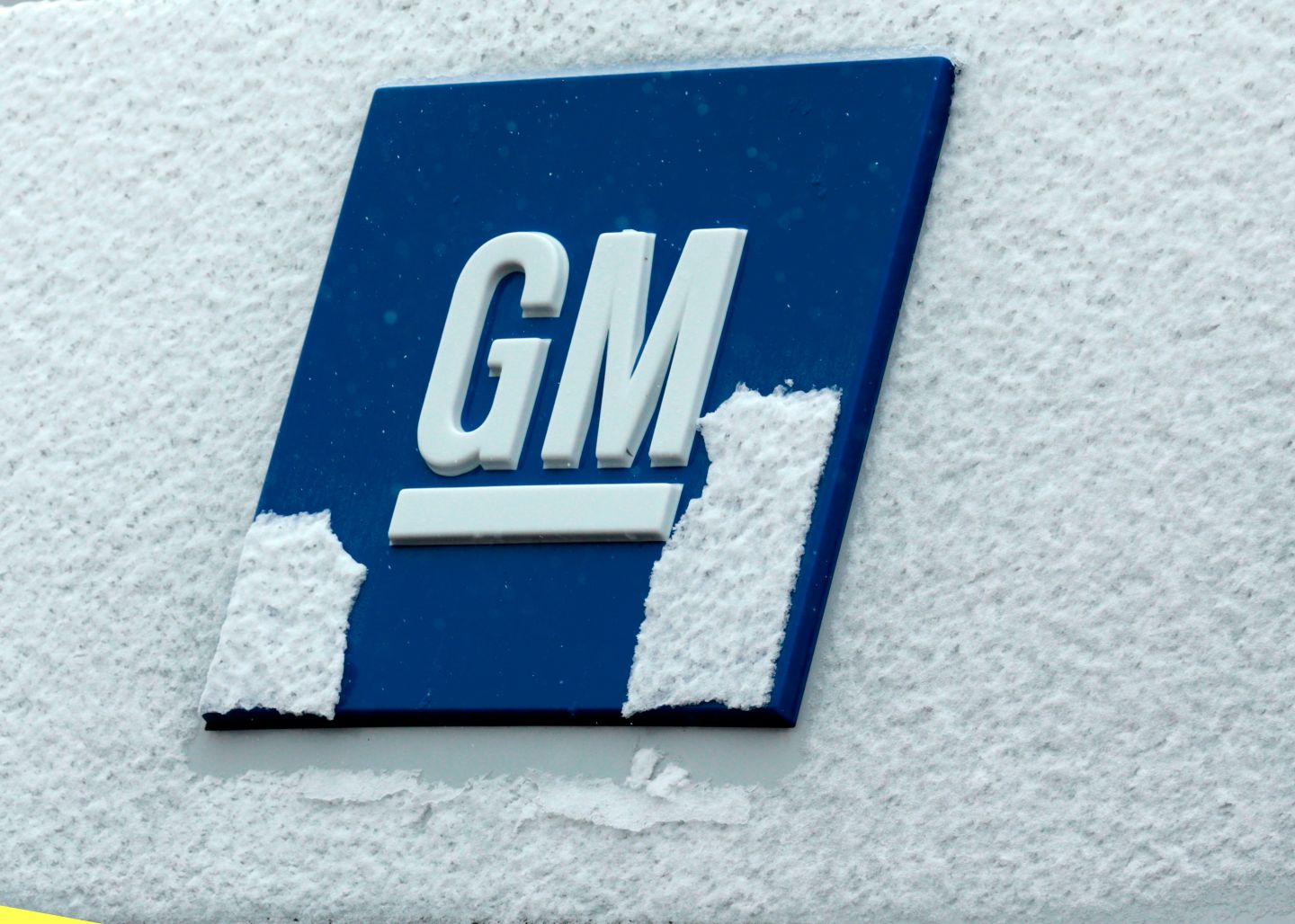 General Motors logo covered in snow.