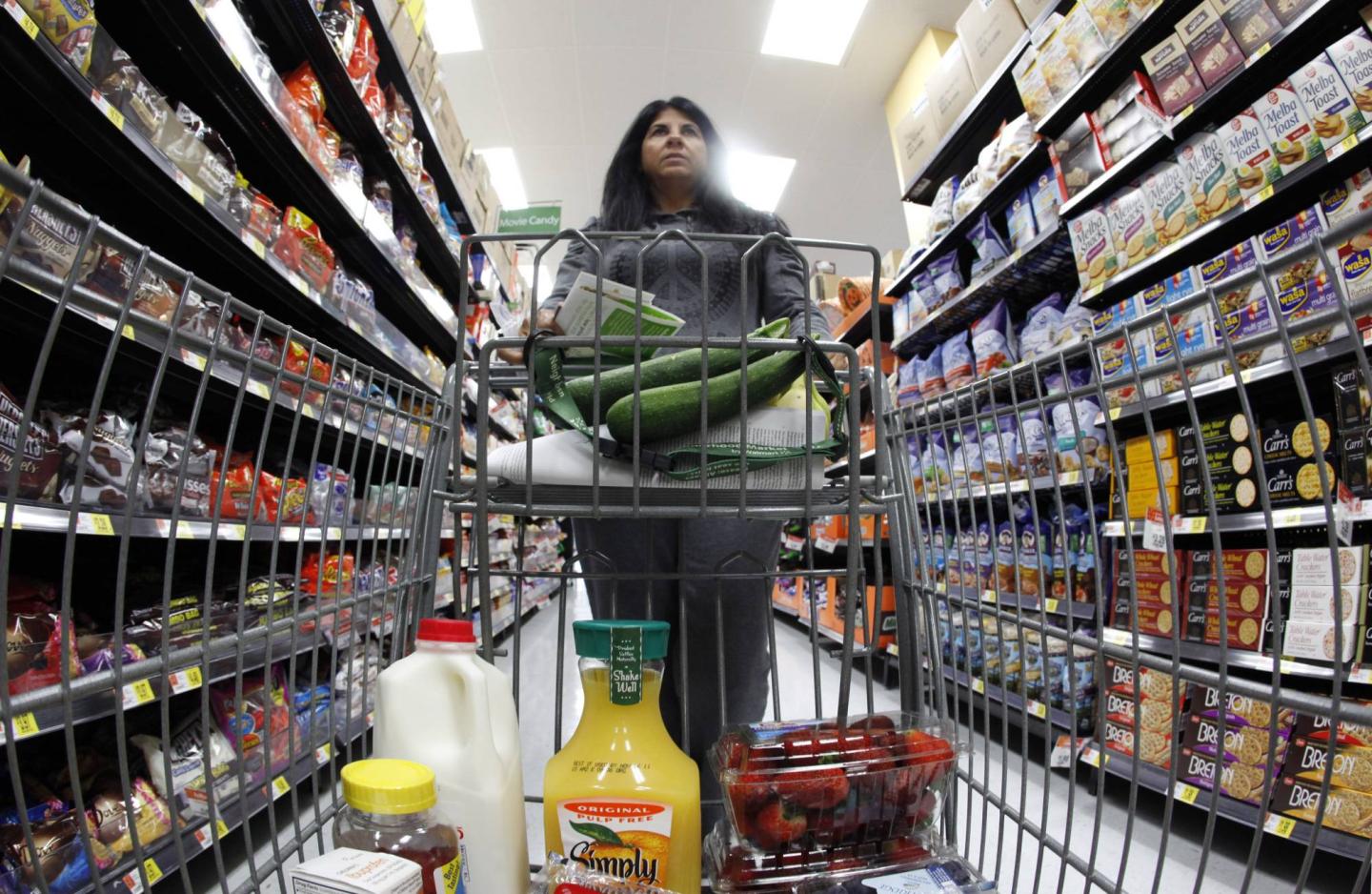 A shopper walks down an aisle in a newly opened Walmart Neighborhood Market in Chicago
