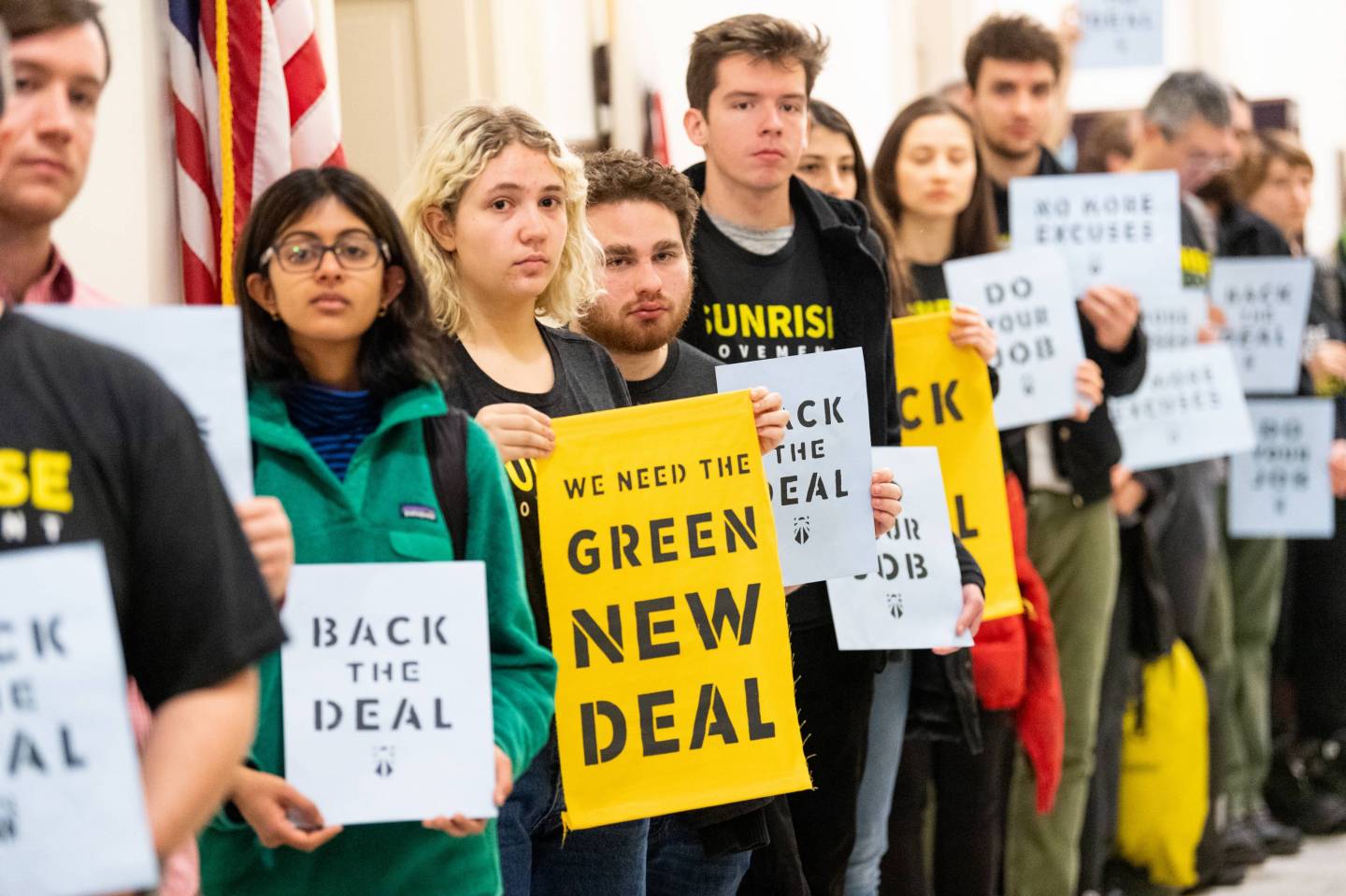 Protesters seen holding placards during the Sunrise Movement