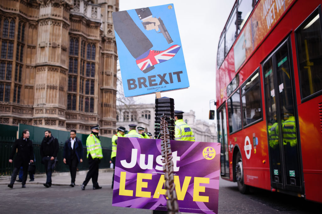 Pro and anti-Brexit placards stand outside the Houses of