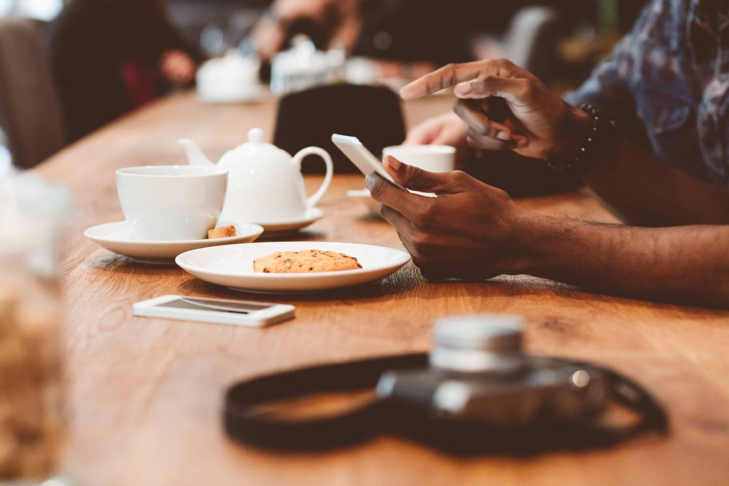 Afro amercian man using smart phone in coffee shop