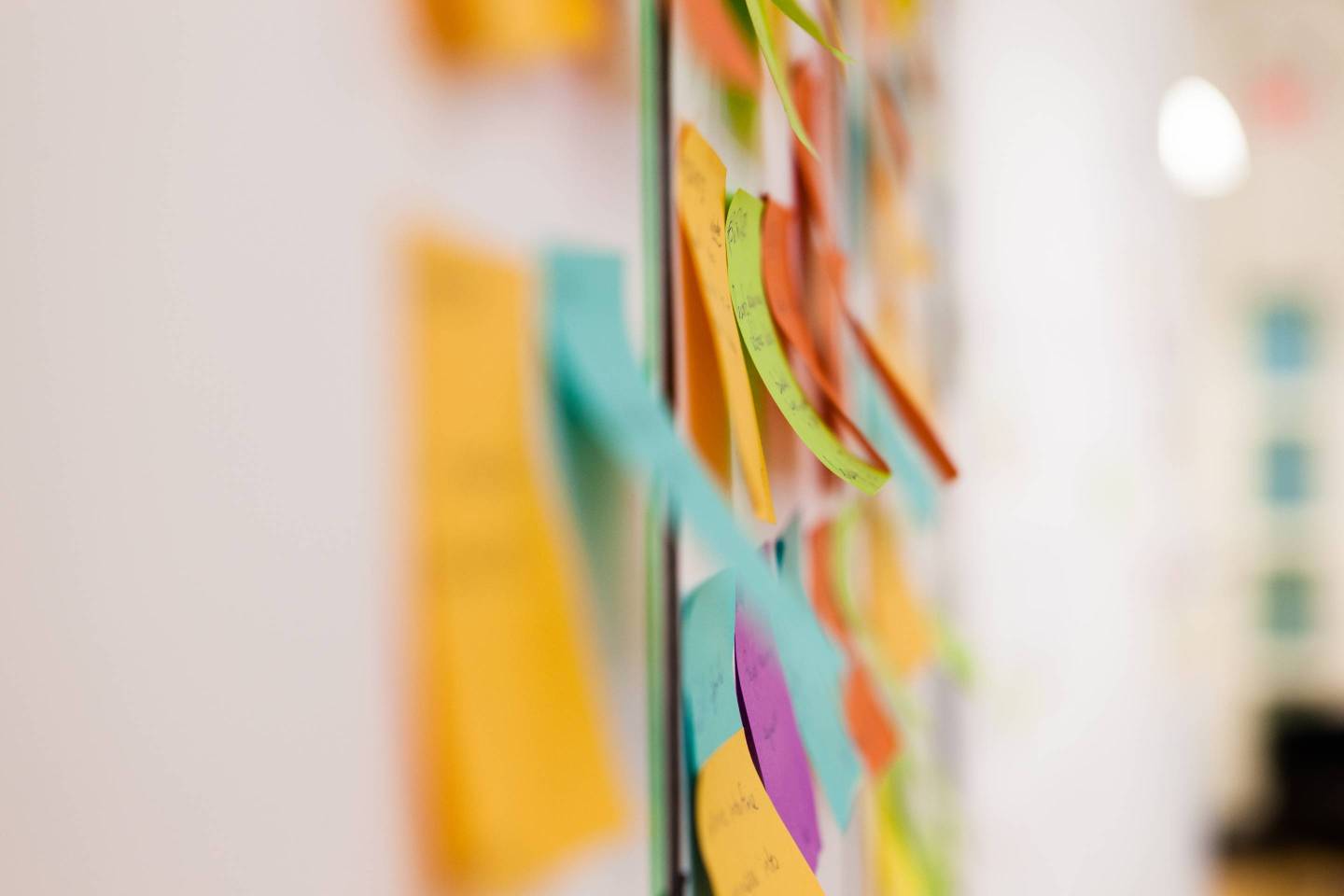 Multicolored sticky notes on whiteboard